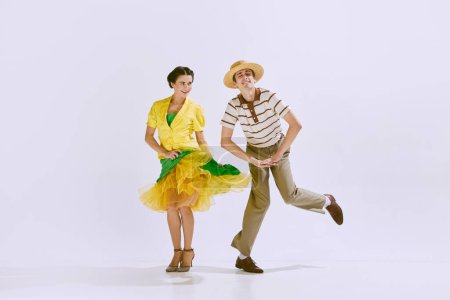 Photo for Enjoyment and fun. Young beautiful couple, man and woman dancing isolated on white studio background. Concept of art, hobby, retro dance, vintage style, choreography, beauty. Ad - Royalty Free Image