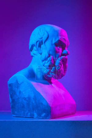 Photo for Male head. Antique statue bust against gradient purple studio background in neon lights. Concept of antique style, classic art, museum, history and mythology. Poster, ad - Royalty Free Image