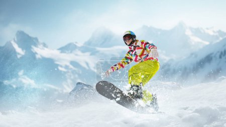 Photo for Young girl in sportswear sliding on snowboard over snowy mountains background. Winter activity. Concept of winter sport, action, motion, hobby, leisure time. Banner. Copy space for ad - Royalty Free Image