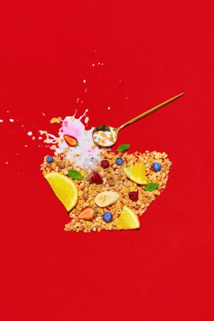 Photo for Ingredients for healthy breakfast. Muesli, cereal with fresh berries and spoon of milk in shape of bowl against red background. Concept of healthy food, nutrition, pop art. Poster. Copy space for ad - Royalty Free Image