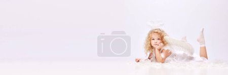 Photo for Dreams. Tender, cute little baby girl, child in image of angel isolated over white studio background. Concept of childhood, imagination, fantasy, fashion and beauty, holidays. Banner - Royalty Free Image