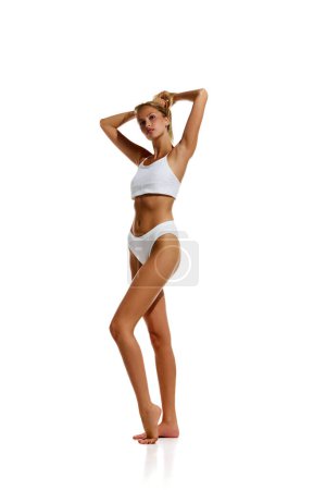 Photo for Tender, elegant, pretty young girl with slim, fit body shape posing in underwear against white background. Concept of natural beauty, body and skin care, health, sport, wellness. Copy space for ad - Royalty Free Image