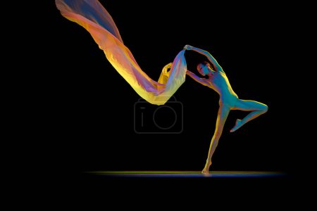 Photo for Elegant ballerina, young woman making performance, dancing with transparent fabric isolated on black studio background in neon light. Concept of beauty, classical dance, art, elegance, choreography - Royalty Free Image