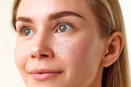 Photo for Close-up image of well-kept, healthy female with no makeup isolated over white studio background. Concept of natural beauty, skincare, cosmetics and cosmetology - Royalty Free Image