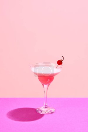 Photo for Pink lady, Clover club cocktail with cherry decorations standing against pink background. Sweet, fresh taste. Concept of alcohol drinks, party, holidays, bar, mix. Poster. Copy space for ad - Royalty Free Image