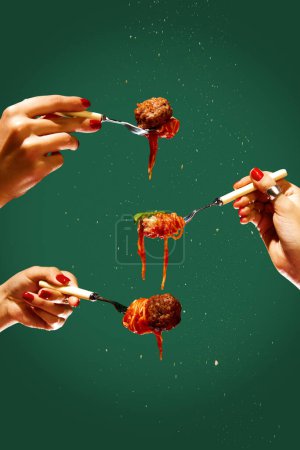 Photo for Female hands holding forks with spaghetti and meatball over green background. Tomato sauce and basil. Concept of Italian food, cuisine, taste, cooking, menu. Pop art. Poster, ad - Royalty Free Image