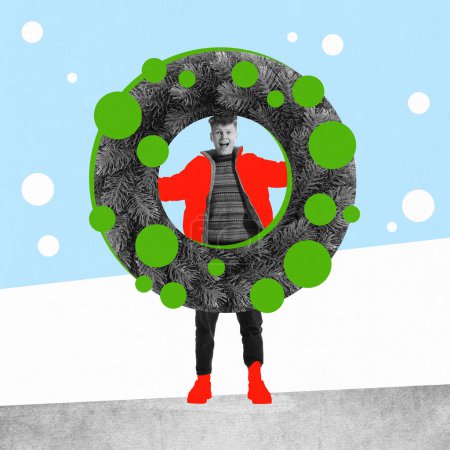 Photo for Happy, smiling, excited young man standing with giant wreath. Decorations. Contemporary art collage. Concept of winter holidays, Christmas and New Year, vacation. Creative design. Poster, postcard. Ad - Royalty Free Image
