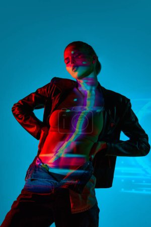 Photo for Attritive young woman with slim, relief body posing against blue background with neon lights reflection on body. Concept of modern art, beauty, style, futurism and cyberpunk, creativity - Royalty Free Image