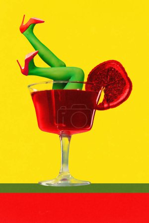 Female legs in green tights and reds heels sticking out alcohol cocktail on yellow background. Contemporary artwork. Poster. Concept of party, alcohol drink, inspiration, fun, Complementary colors.