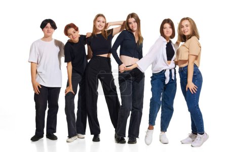 Photo for Group of diverse young attractive girls, teenagers in casual outfit stands in line against white studio background. Concept of beauty, youth, emotions, fashion, style, modelling. Copy space for ad. - Royalty Free Image