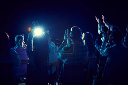 Photo for Group of of different people applauding, attending concert, stand up show, cheerfully spending time with jokes and funny stories. Concept of entertainment, fun and joy, concert, performance - Royalty Free Image