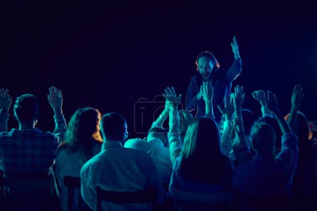Photo for Emotional man, business couch and tutor standing on stage and giving motivational speech to employees. Concept of business, education, partnership, coaching, entrepreneurship, growth - Royalty Free Image
