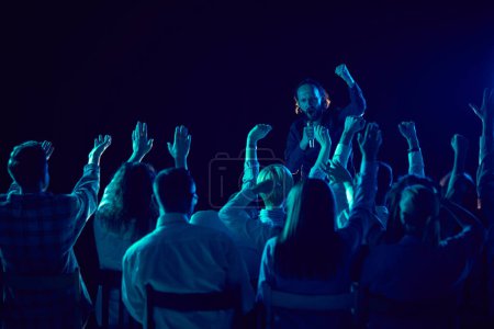 Photo for Emotional man, business couch and tutor standing on stage and giving motivational speech to employees. Concept of business, education, partnership, coaching, entrepreneurship, growth - Royalty Free Image