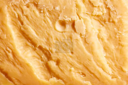 Photo for Close-up image, texture of yellow colored, hard cheese, Cheddar. Traditional taste of Italian cheese. Salty and delicious. Concept of food, taste, art of organic products, healthy, natural food. - Royalty Free Image