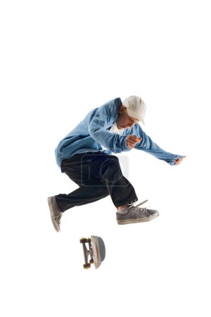 Photo for Dynamic image of sportive young man in casual clothes in motion, raining, jumping with skateboard isolated over white background. Concept of professional sport, competition, training, action. - Royalty Free Image