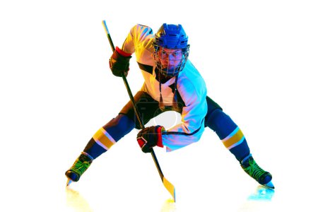 Photo for Goalkeeper. Concentrated young girl, hockey payer ion motion, standing with stick during game against white background in neon light. Concept of professional sport, competition, game, action, hobby - Royalty Free Image
