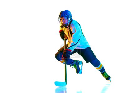 Photo for Dynamic image of young woman, hockey payer i n motion during game, training, playing against white background in neon light. Concept of professional sport, competition, game, action, hobby - Royalty Free Image