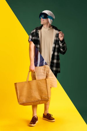 Photo for Collage. Halves of male portraits. Summer vs winter seasons. Young man in warm and summer clothes over green yellow background. Concept of human emotions, lifestyle, youth culture - Royalty Free Image