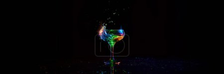 Photo for Glass with alcohol cocktail with martini standing against dark background with neon light. Banner. Concept of alcohol drink, nightclub, party, taste, celebration. Empty space to insert text - Royalty Free Image