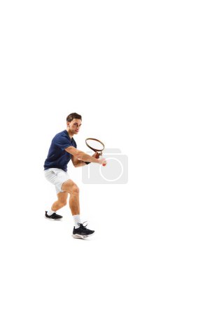 Photo for Full-length dynamic image of young man in his 30s, tennis plyer in motion, practicing, training isolated over white background. Concept of professional sport, competition, game, math, hobby, action - Royalty Free Image
