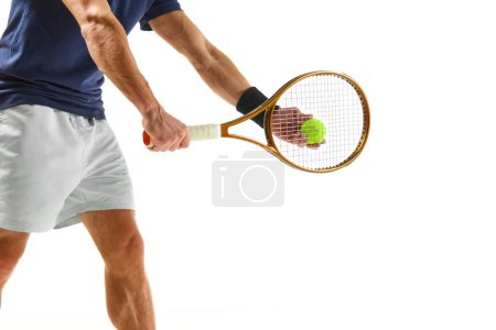 Photo for Cropped image of male tennis player in blue shirt and white shorts, serving ball with racket isolated over white background. Concept of professional sport, competition, game, math, hobby, action - Royalty Free Image