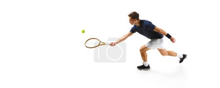Photo for Top view. Concentrated man in his 30s, tennis athlete in motion during game,. practicing isolated over white background. Concept of professional sport, competition, game, math, hobby, action - Royalty Free Image