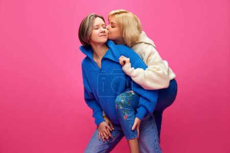 Photo for Happy young women in casual clothes showing love, kissing over pink studio background. Concept of lgbt community, love, Valentines day, freedom, acceptance, February 14th - Royalty Free Image
