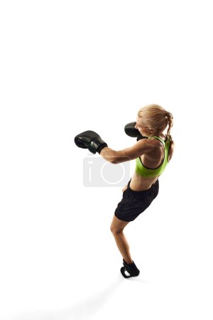Photo for Left hook punch. Sportive young woman, boxing athlete with slim muscular body training isolated over white background. Concept of sport, active and healthy lifestyle, strength and endurance, body care - Royalty Free Image
