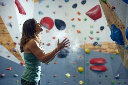 Photo for Young athletic woman, bouldering instructor training, practicing indoors, climbing wall. Ready to start. Concept of bouldering, sport climbing, hobby, active lifestyle, school, training course - Royalty Free Image