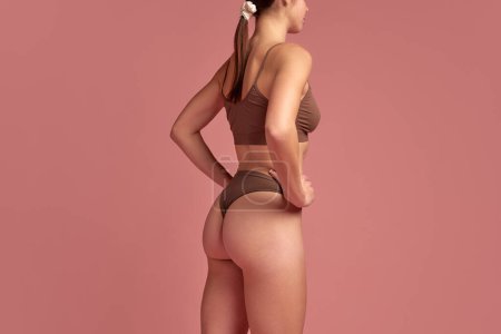 Photo for Cellulite reduction products. Cropped image of female slim body, buttocks in underwear against pink background. Smooth skin. Concept of natural beauty, health and body care, cosmetology, massage - Royalty Free Image