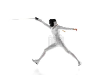 Photo for Sport equipment. The fencing foil, mask, and suit represent the essential equipment for the sport. Female fencing athlete training isolated over white background. Concept of sport, championship - Royalty Free Image