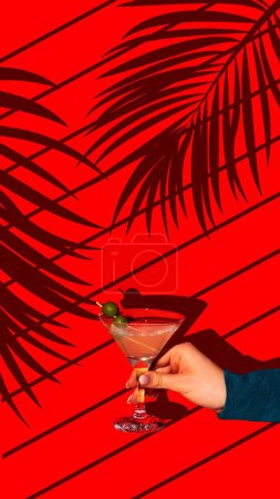 Photo for Contemporary art collage. Neon Martini. Female Hand holds sweet and sour cocktail garnished with green olives against vivid background with plants shadows. Concept of parties and holidays, summertime. - Royalty Free Image