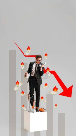 Photo for Financial crisis communication, strategies in business. Conceptual design. Businessman chained to phone, financial charts falling, burning money, overwhelmed. Concept of economy, crisis, business - Royalty Free Image