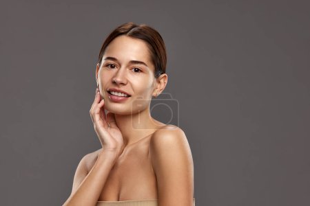 Photo for Portrait of beautiful young woman with spotless, well-kept, healthy sooth skin without makeup against studio background. Concept of natural beauty, cosmetology and cosmetics, skin care - Royalty Free Image