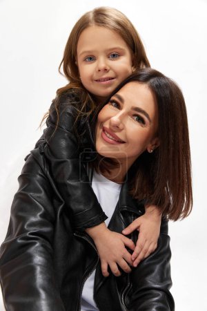 Photo for Stylish family. Happy beautiful woman, mother posing with little adorable kid, daughter against white studio background. Concept of happiness, Mothers day, childhood, fashion and lifestyle - Royalty Free Image