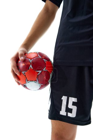 Photo for Cropped image f male hand holding handball ball against white studio background. Poster for upcoming sport event, sport school. Concept of professional sport, tournament, competition - Royalty Free Image