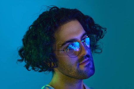 Photo for Young man wearing glasses, looking at pc screen with graphs reflection at eyewear. Using internet, working online, AI, business. Concept of youth, human emotions, lifestyle, business, trading - Royalty Free Image
