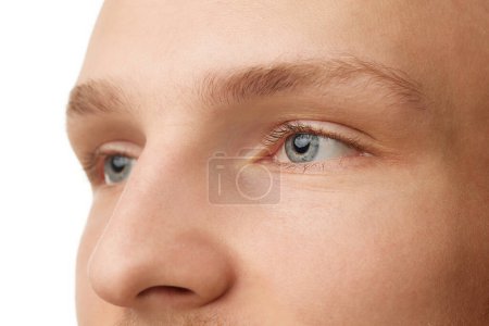 Photo for Close-up of male face, nose and eyes isolated against white studio background. Blue eyes, spotless skin. Vision, health care. Concept of skin care, male beauty and cosmetics, youth, spa, self-care - Royalty Free Image