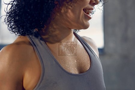 Close up of young woman in sportswear, tank top wet after productive weightlifting training at gym. Concept of professional sportsman, healthy and active lifestyle, workout. Ad