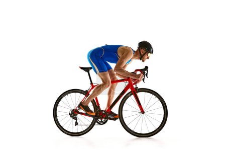 Photo for Concentrated and motivated man in sportswear and helmet, bicyclist in motion, training isolated on white studio background. Concept of sport, active and healthy lifestyle, speed, endurance, hobby - Royalty Free Image