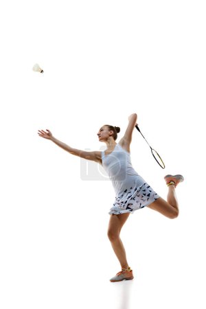 Photo for Concentrate young woman, badminton athlete in motion playing isolated over white background. Winning game. Concept of professional sport, active lifestyle, hobby, game - Royalty Free Image