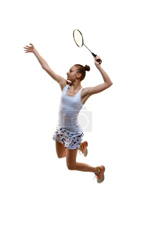 Photo for Full-length image of motivated athlete in motion, young girl, badminton player hitting shuttlecock in jump isolated over white background. Concept of professional sport, active lifestyle, hobby, game - Royalty Free Image