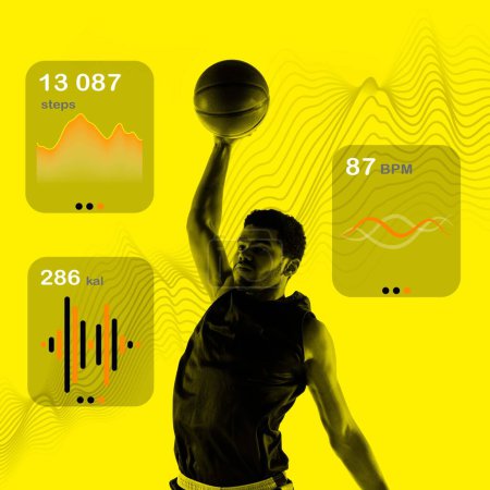 Photo for Athletic young muscular man, basketball player in motion, playing against yellow background with health tracking graphics. Concept of sport, active and heathy lifestyle, training - Royalty Free Image