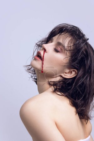 Elegant, beautiful young woman with jewelry imitating blood nose. Aesthetic medicine impact on self acceptance. Concept of modern beauty standards, plastic surgery, health, cosmetology