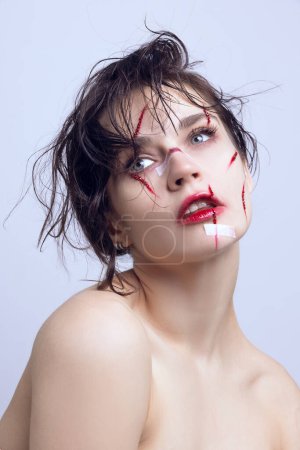 Photo for Challenging beauty ideals. Young beautiful woman with red scratches and plaster on face. Facial treatment. Concept of modern beauty standards, plastic surgery, health, cosmetology - Royalty Free Image