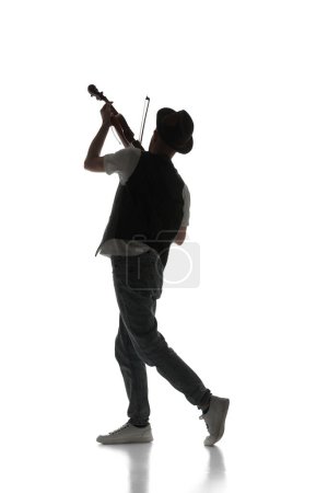 Photo for Male silhouette, talented young musician playing violin isolated on white background. Black and white image. Concept of music, festival, concert, entertainment, instruments. Poster, ad - Royalty Free Image