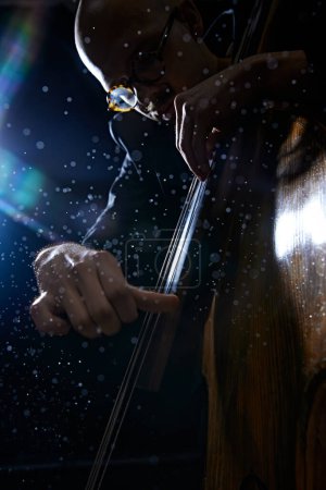 Photo for Male musician playing double bass against black background with lights elements. Classical music performance. Concept of music, instruments, concert, sound, equipment, festival - Royalty Free Image