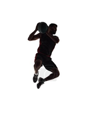 Photo for Silhouette of male basketball player in motion during game, training, playing isolated on white background. Full-length. Concept of professional sport, competition, game, tournament, action - Royalty Free Image