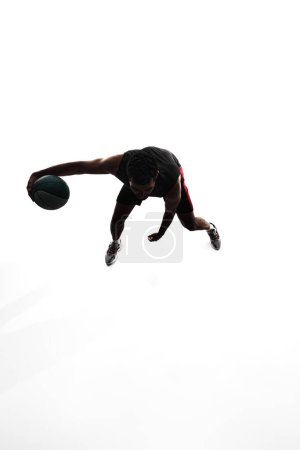 Photo for Top view image, silhouette of man, basketball player in motion during game, training, playing isolated on white background. Concept of professional sport, competition, game, tournament, action - Royalty Free Image