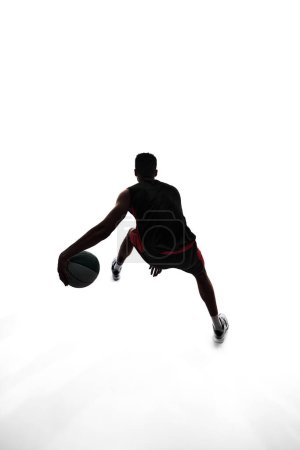 Photo for Silhouette of basketball player in motion with ball, make athlete playing isolated on white background. Concept of professional sport, competition, game, tournament, action - Royalty Free Image